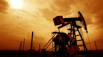 Oil and gas well profiled on dramatic sky